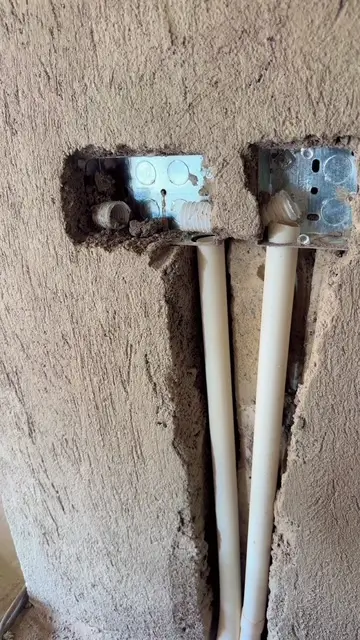Electrician repairing power socket in Kampala
