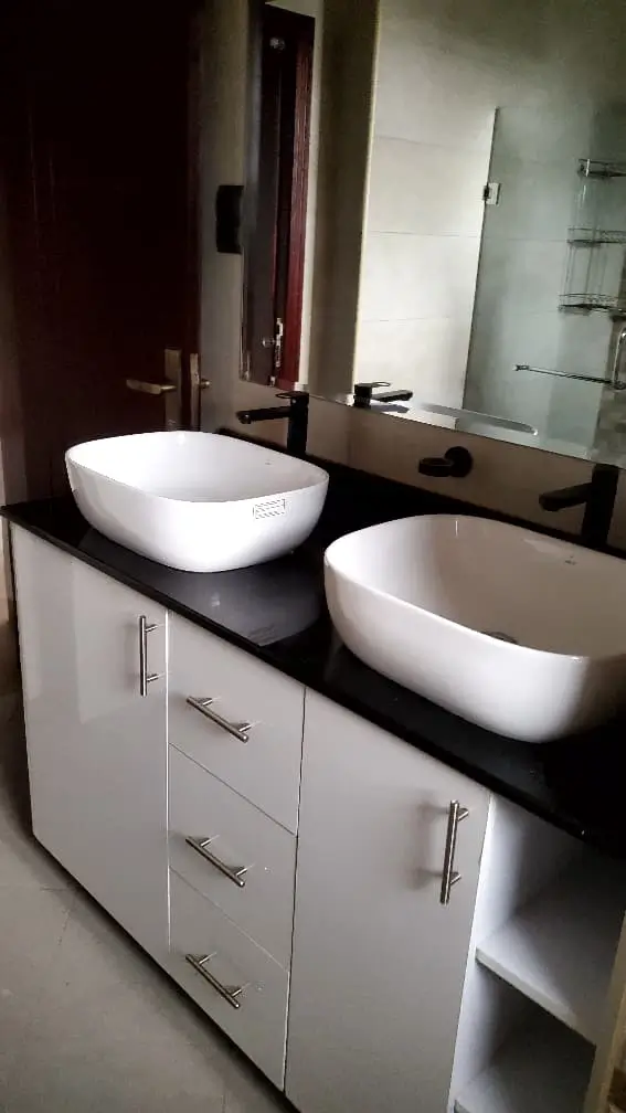 Professional plumber repairing water leak in Kampala home, Uganda